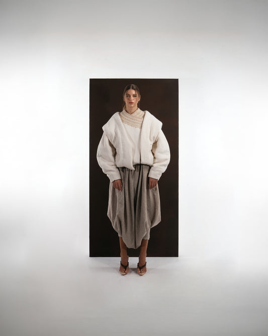 ALISADUDAJ ivory and beige wool cocoon jacket and draped trouser set, front view showing oversized padded sleeves and beige embroidered yoke