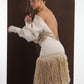 ALISADUDAJ ivory wool fringed dress, back view with arm extended showing blouson sleeve and fringe