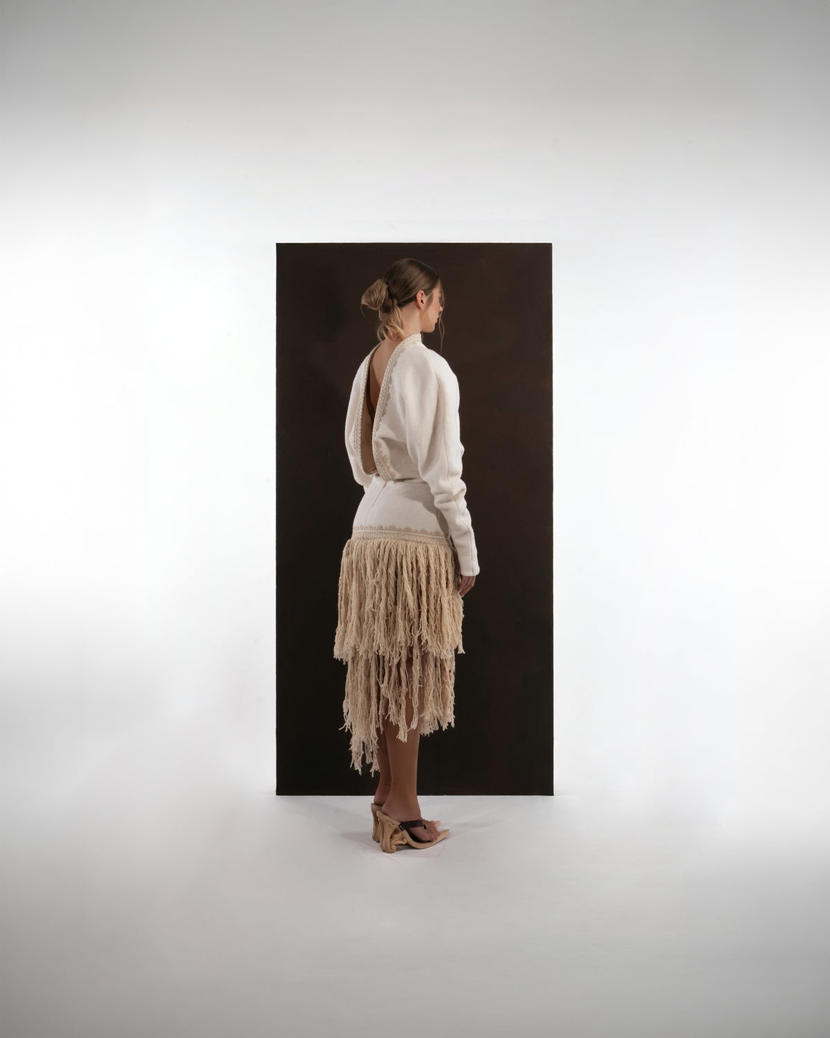 ALISADUDAJ ivory wool fringed dress, back view showing deep open back with braid trim and tiered fringe