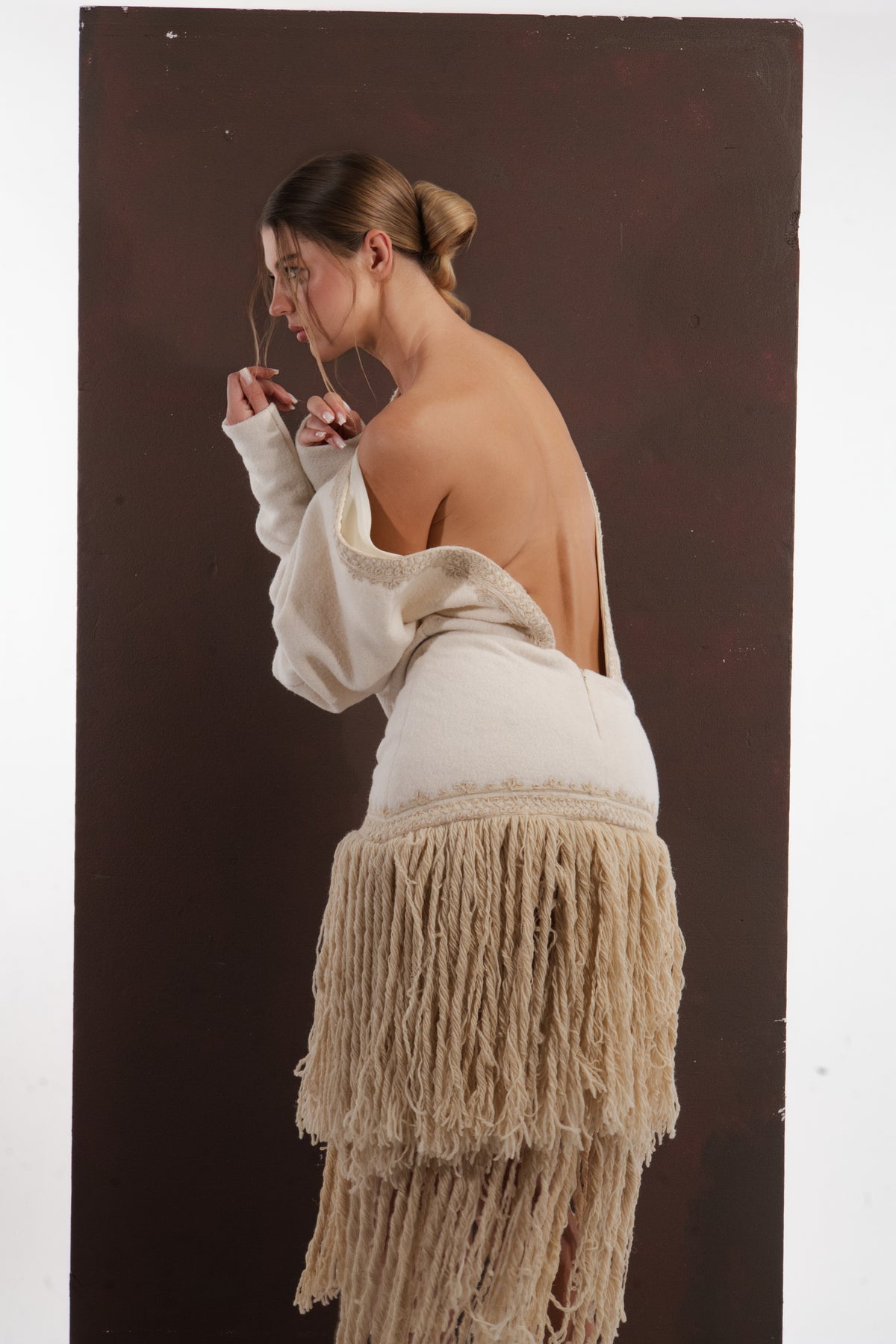 ALISADUDAJ ivory wool fringed dress, back close-up of braid-trimmed open back and fringe layers, wool