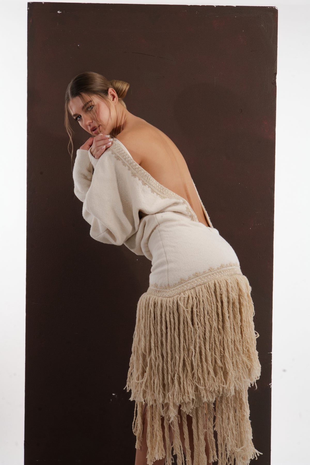 ALISADUDAJ ivory wool fringed dress, back three-quarter view showing braid trim along the open back