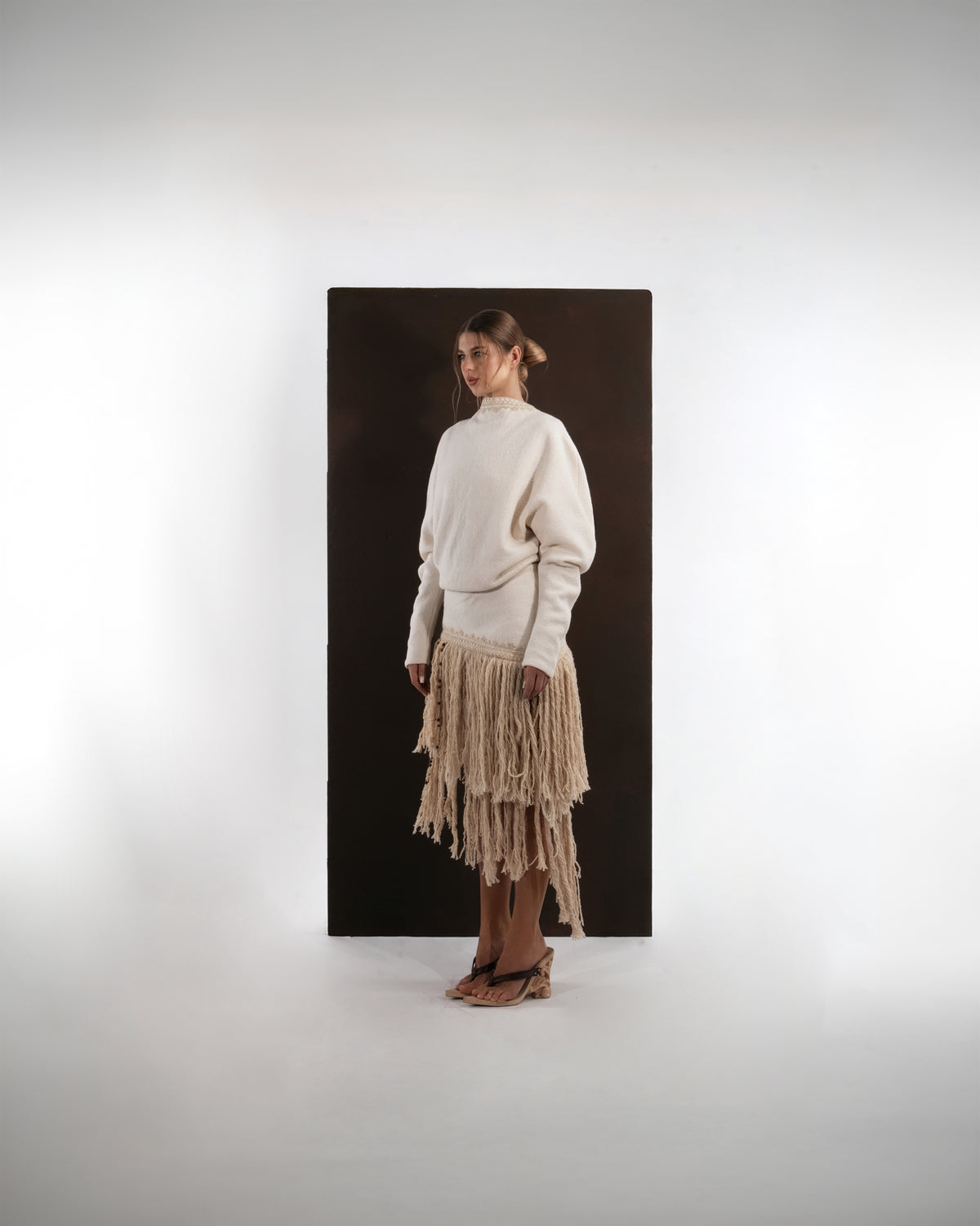 ALISADUDAJ ivory wool fringed dress, side three-quarter view showing blouson bodice and fringe layers