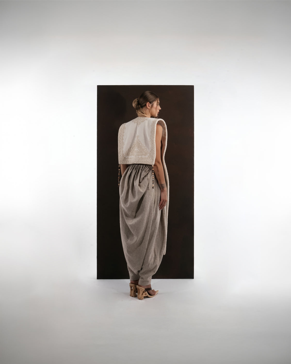 ALISADUDAJ ivory and grey wool beaded hooded vest and draped trouser set, back view with hood down showing jacquard back panel