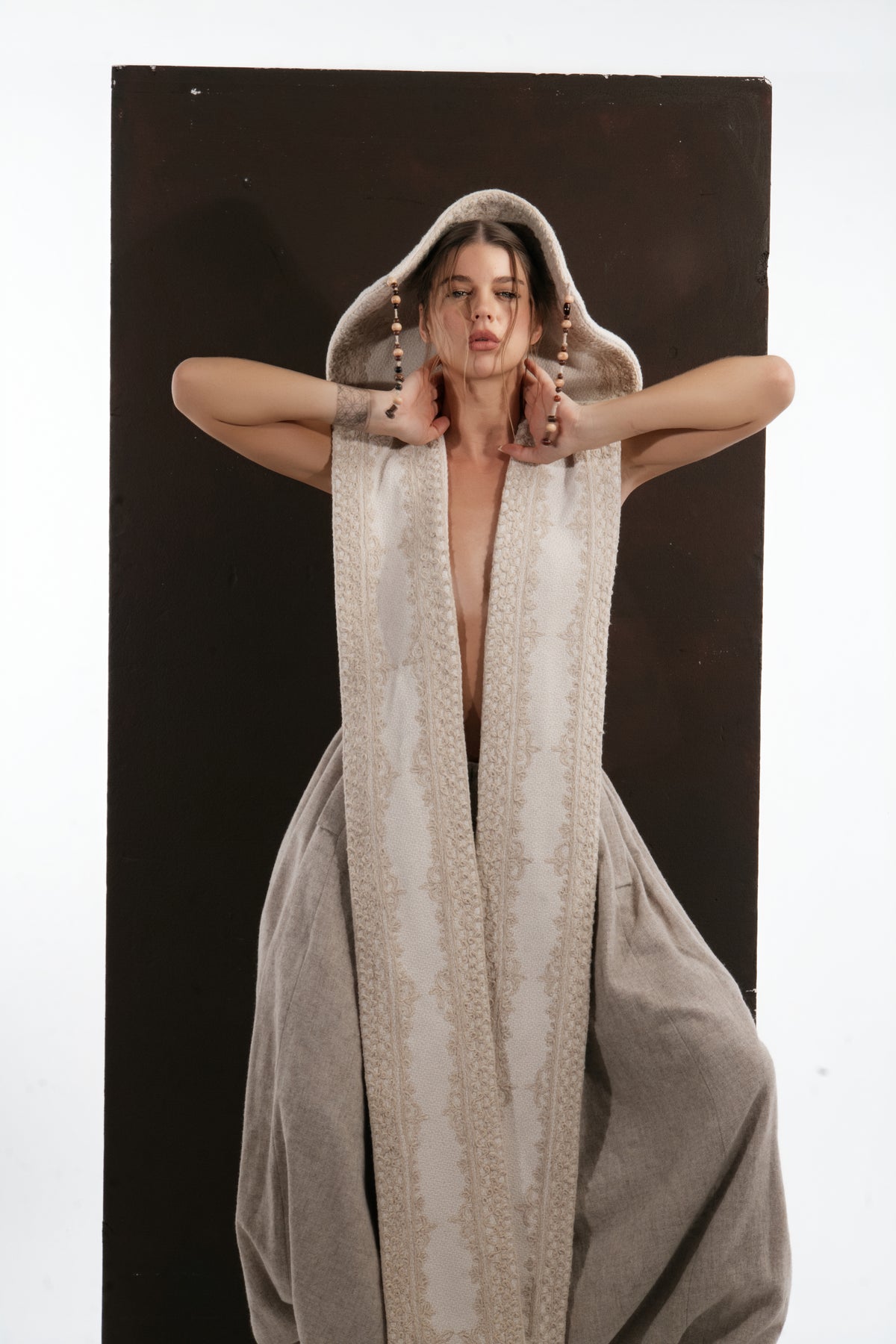ALISADUDAJ ivory wool beaded hooded vest, front close-up of open-front jacquard border and beaded cords, wool blend