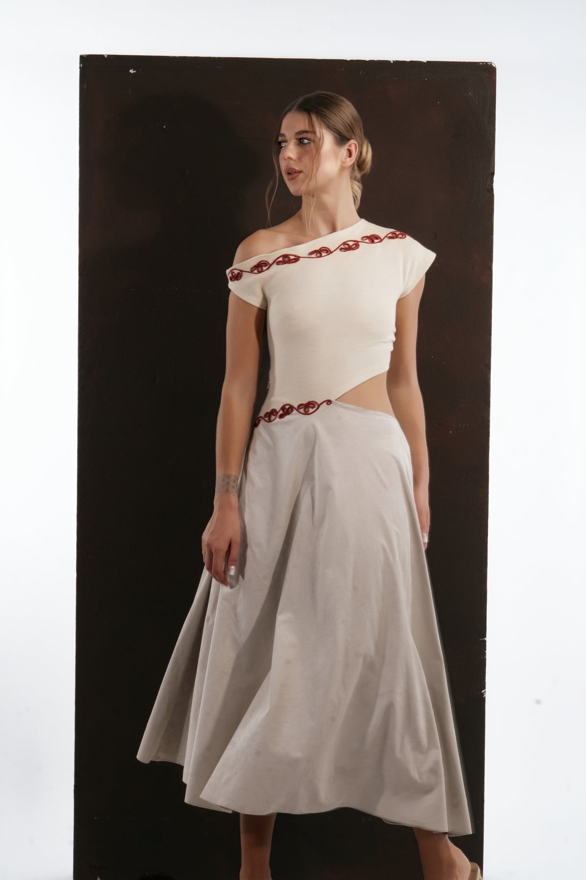 ALISADUDAJ ivory and grey wool red-embroidered dress, three-quarter view showing off-shoulder cap sleeve