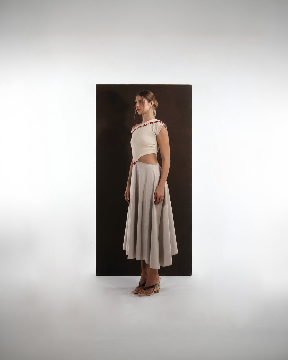 ALISADUDAJ ivory and grey wool red-embroidered dress, side view showing red scroll embroidery at neckline and waist