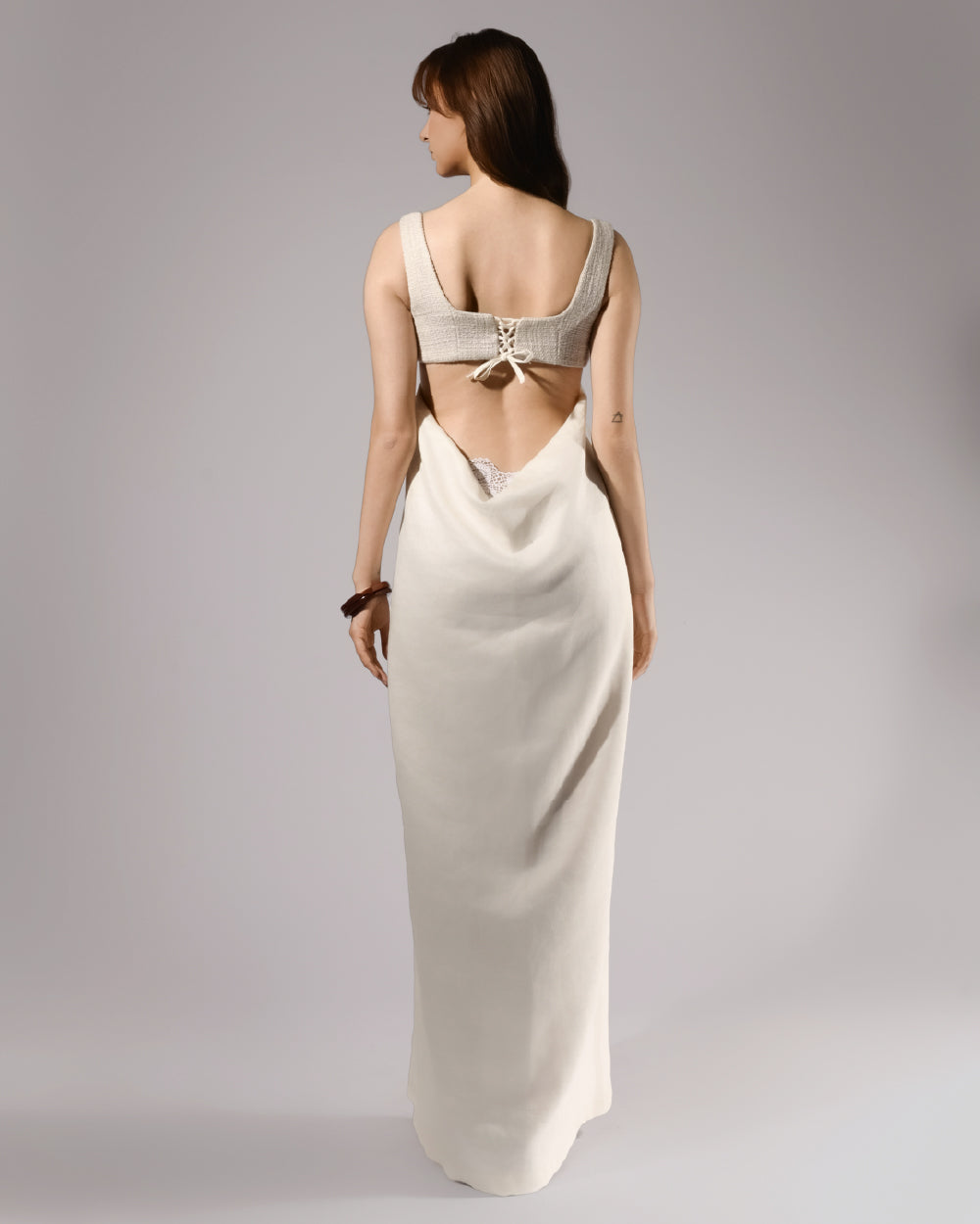 ALISADUDAJ ivory linen empire-waist gown, back view showing lace-up bodice tie and open back