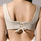 ALISADUDAJ ivory linen empire-waist gown, back close-up of corset lacing and bow tie