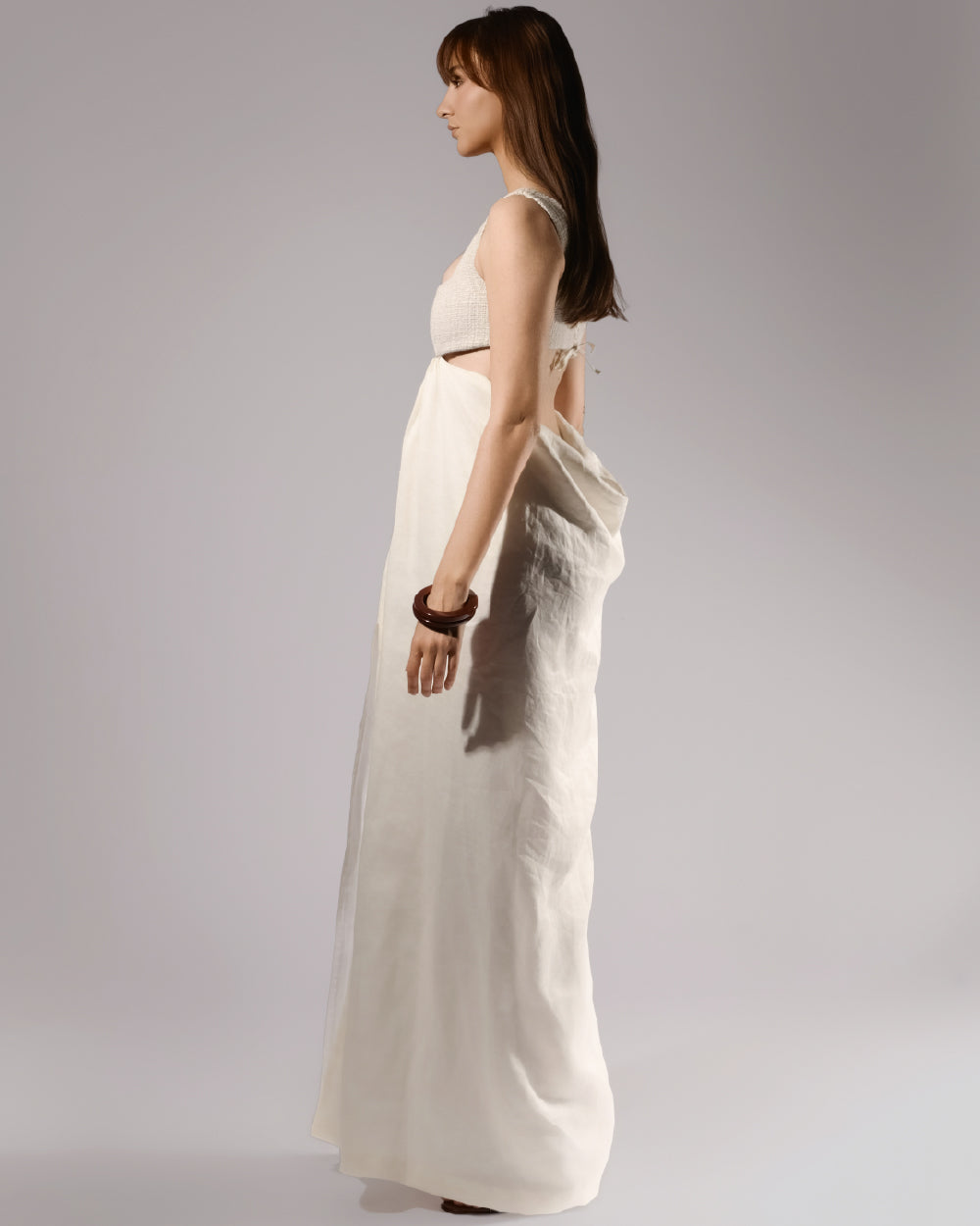 ALISADUDAJ ivory linen empire-waist gown, side profile showing waist cut-out and floor-length skirt