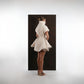 ALISADUDAJ ivory ribbed wool flared mini dress, back three-quarter view showing turtleneck and flared skirt