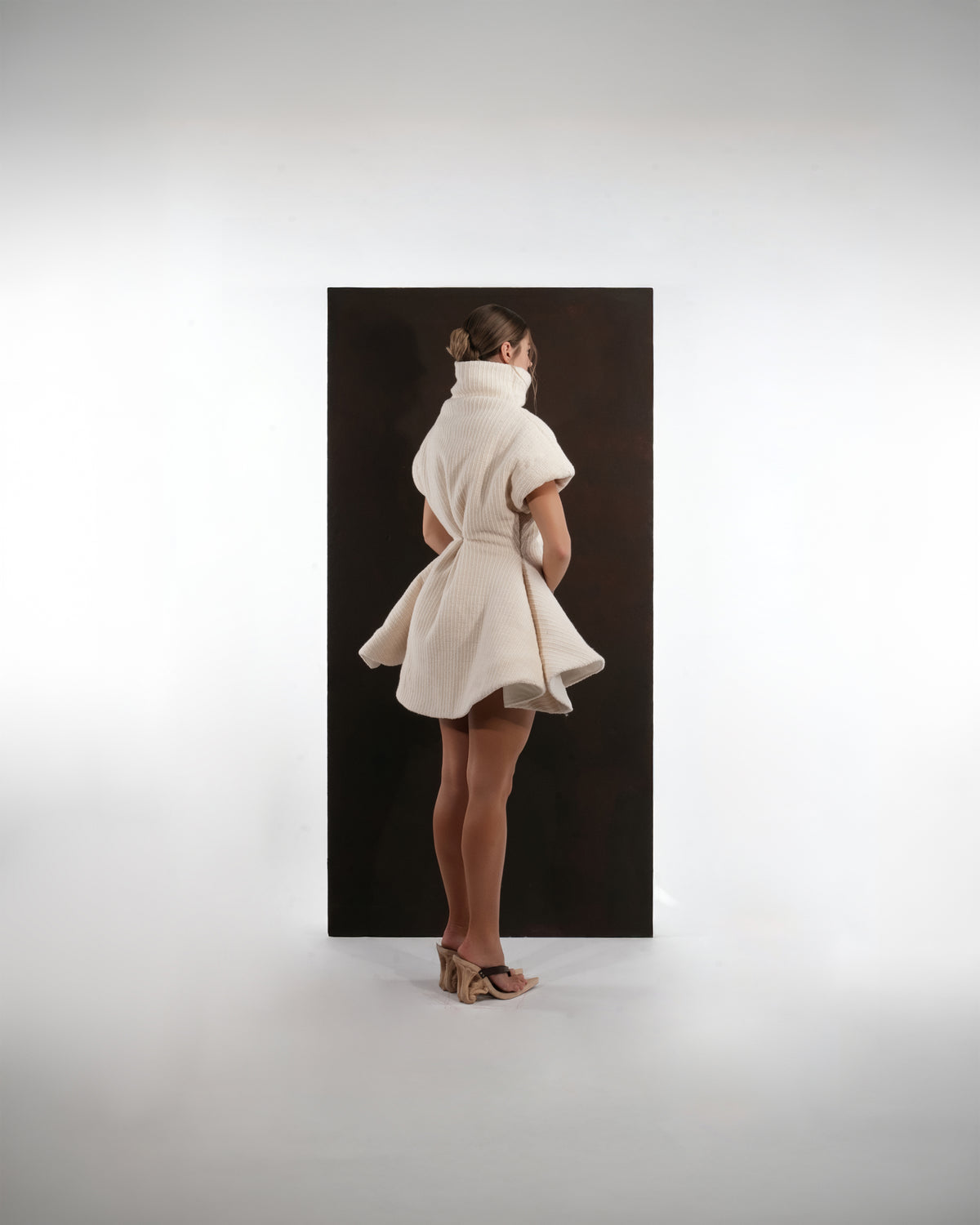 ALISADUDAJ ivory ribbed wool flared mini dress, back three-quarter view showing turtleneck and flared skirt
