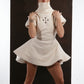 ALISADUDAJ ivory ribbed wool flared mini dress, front view with hands at the collar showing turtleneck
