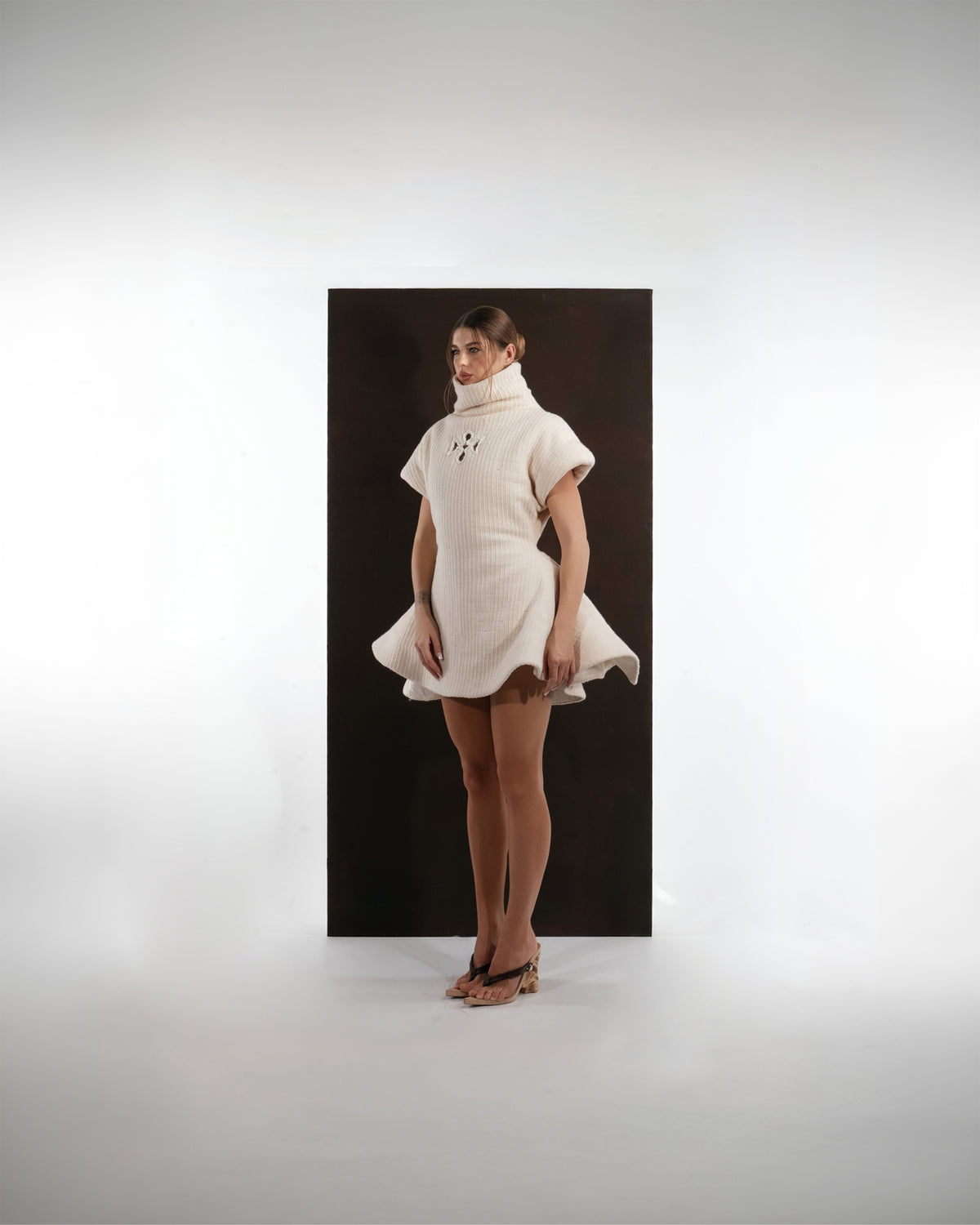 ALISADUDAJ ivory ribbed wool flared mini dress, front three-quarter view showing rib texture and hem volume