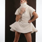 ALISADUDAJ ivory ribbed wool flared mini dress, three-quarter view in movement showing skirt flare