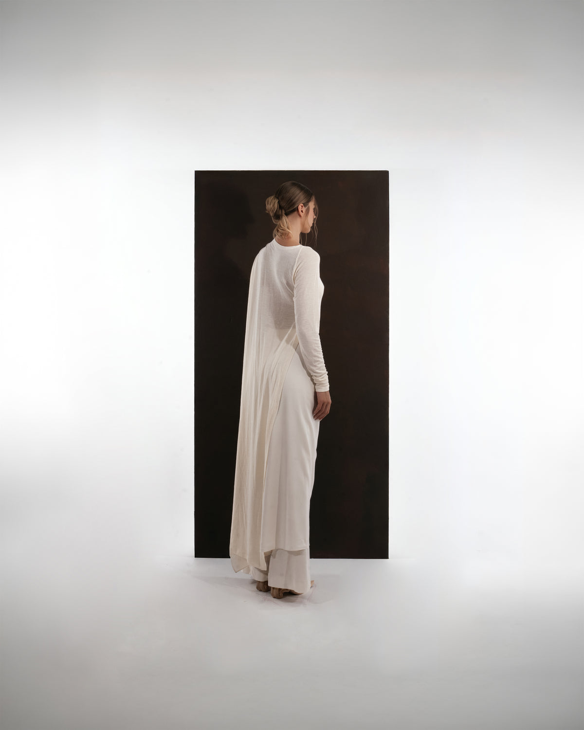 ALISADUDAJ ivory wool draped asymmetric set, back view showing draped panel down the back and long sleeve