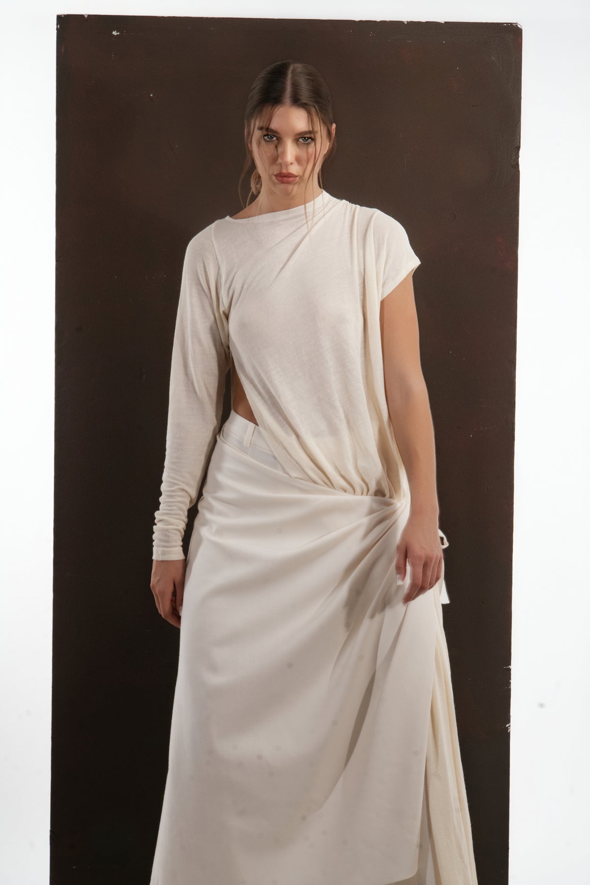 ALISADUDAJ ivory wool draped asymmetric top, close-up of side cut-out and draped skirt tie, wool blend