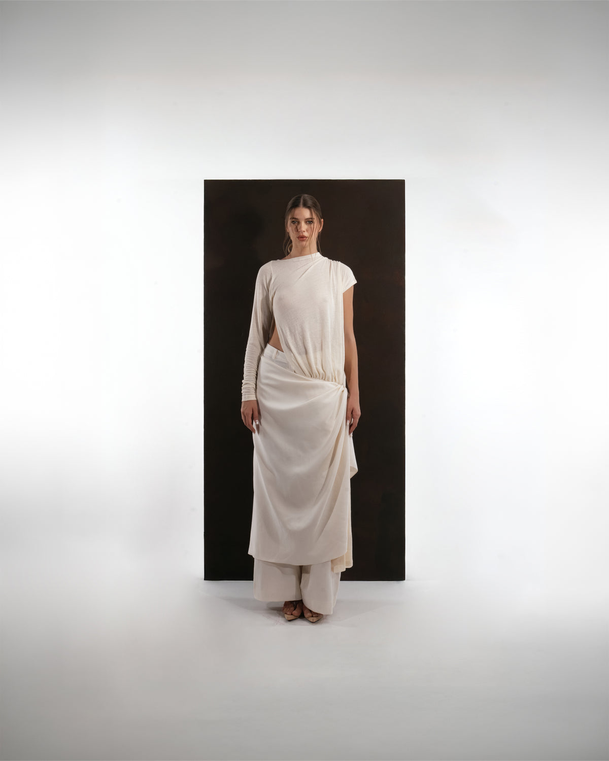 ALISADUDAJ ivory wool draped asymmetric set, front view showing gathered waist drape and layered hem