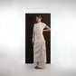 ALISADUDAJ ivory wool draped asymmetric set, three-quarter view with hand behind back showing knotted skirt drape