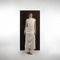 ALISADUDAJ ivory wool draped asymmetric set, front three-quarter view showing side cut-out and draped wrap skirt