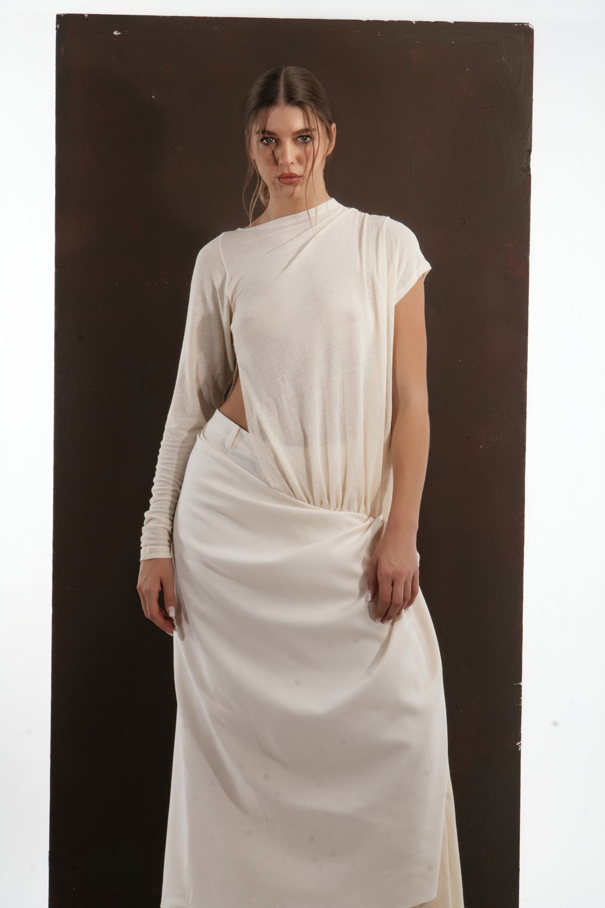 ALISADUDAJ ivory wool draped asymmetric top and wrap skirt, half-length front view showing waist cut-out