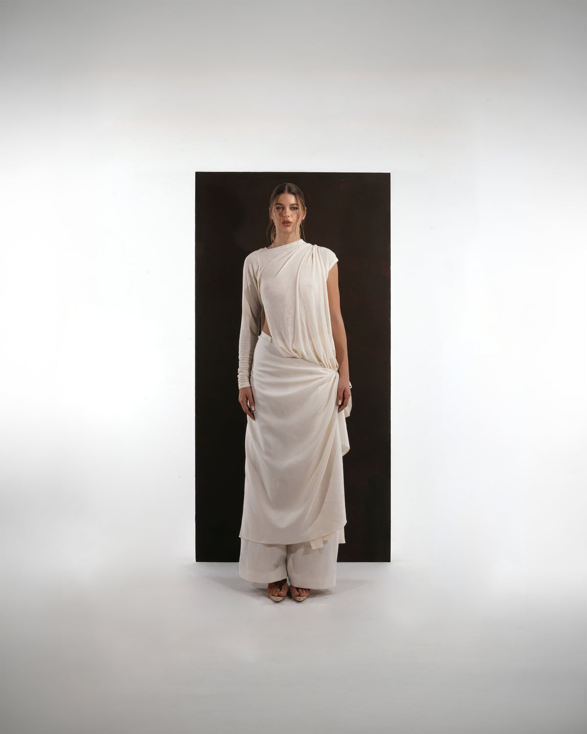 ALISADUDAJ ivory wool asymmetric draped top and wrap skirt set, front view, full length, over wide-leg trousers