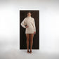 ALISADUDAJ ivory wool draped mini dress, front view with one hand on hip showing draped shoulder