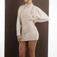 ALISADUDAJ ivory wool draped mini dress, three-quarter view with hand behind back showing sleeve volume