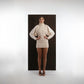 ALISADUDAJ ivory wool draped mini dress, front view with hands on hips showing sculpted sleeve volume