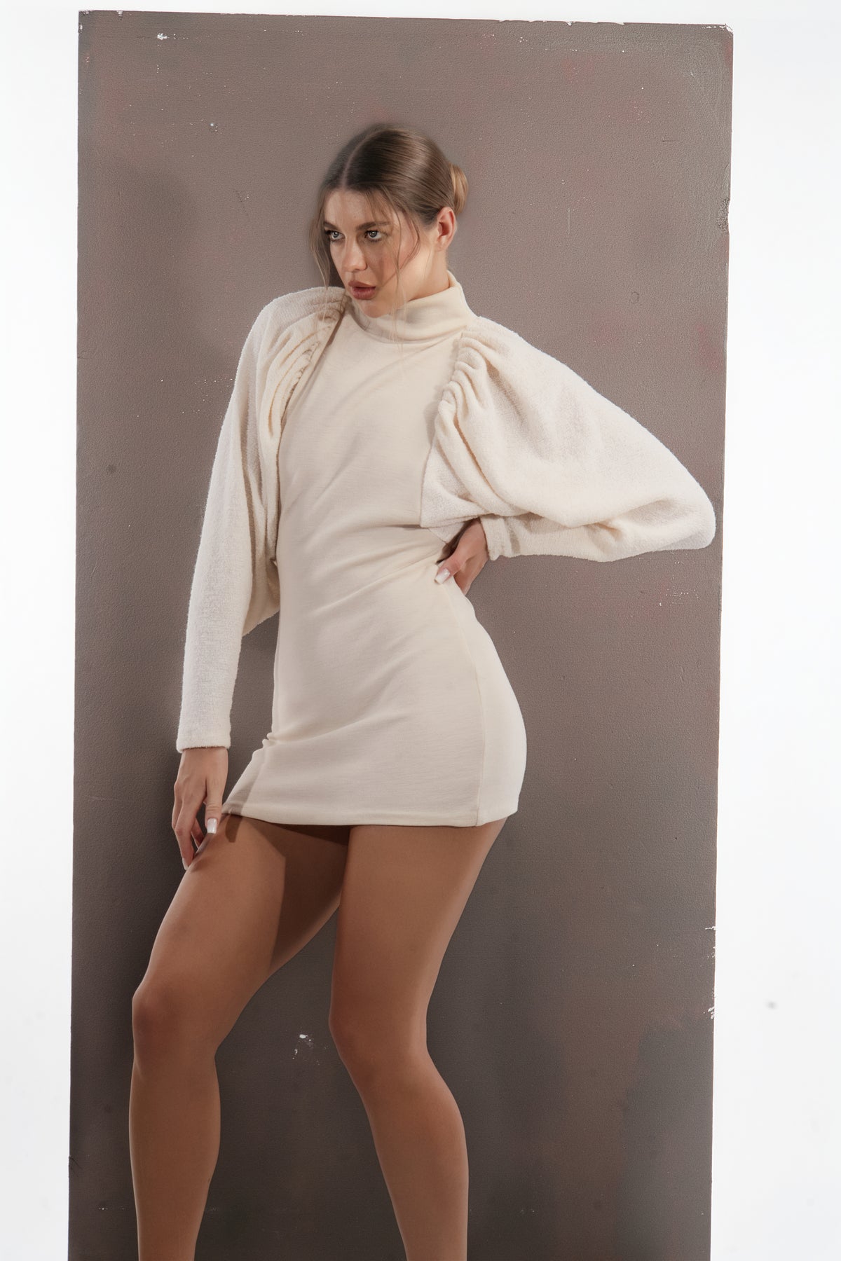 ALISADUDAJ ivory wool draped mini dress, side view showing fitted skirt and balloon sleeve