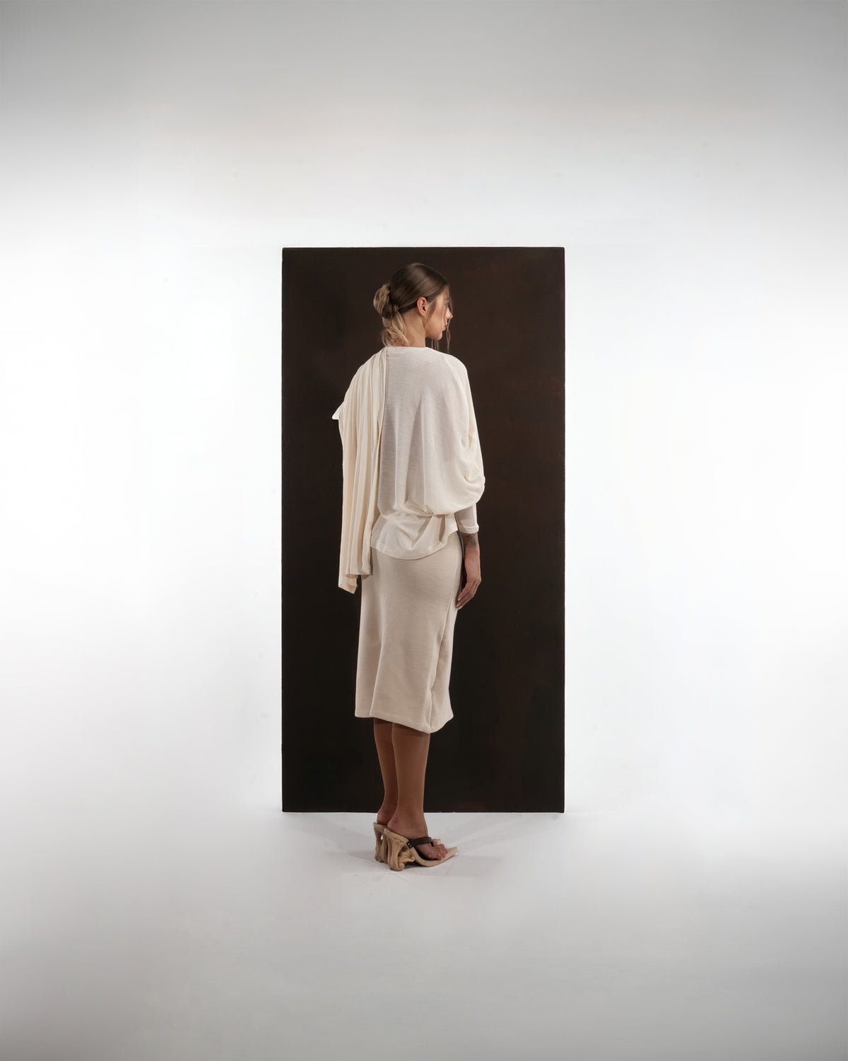 ALISADUDAJ ivory wool draped top and midi skirt set, back view showing draped panel and pencil skirt