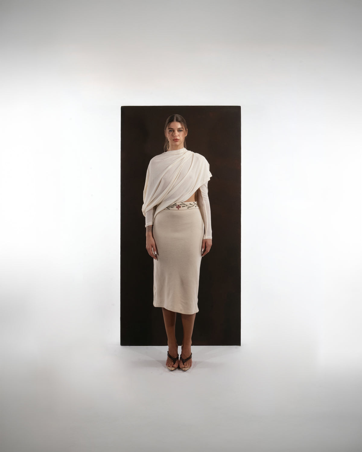 ALISADUDAJ ivory wool set, front view showing red and green floral embroidery along the skirt waistband