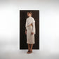 ALISADUDAJ ivory wool draped top and midi skirt set, side three-quarter view showing waist cut-out and drape