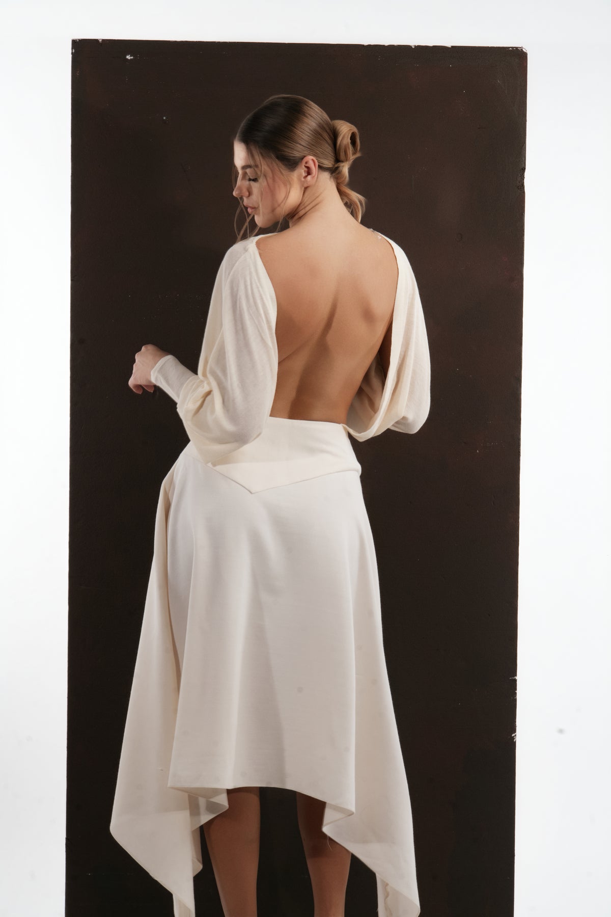 ALISADUDAJ ivory wool open-back drape dress, back three-quarter view showing draped bodice folds