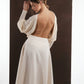 ALISADUDAJ ivory wool open-back drape dress, back view with arm raised showing open back and waist yoke