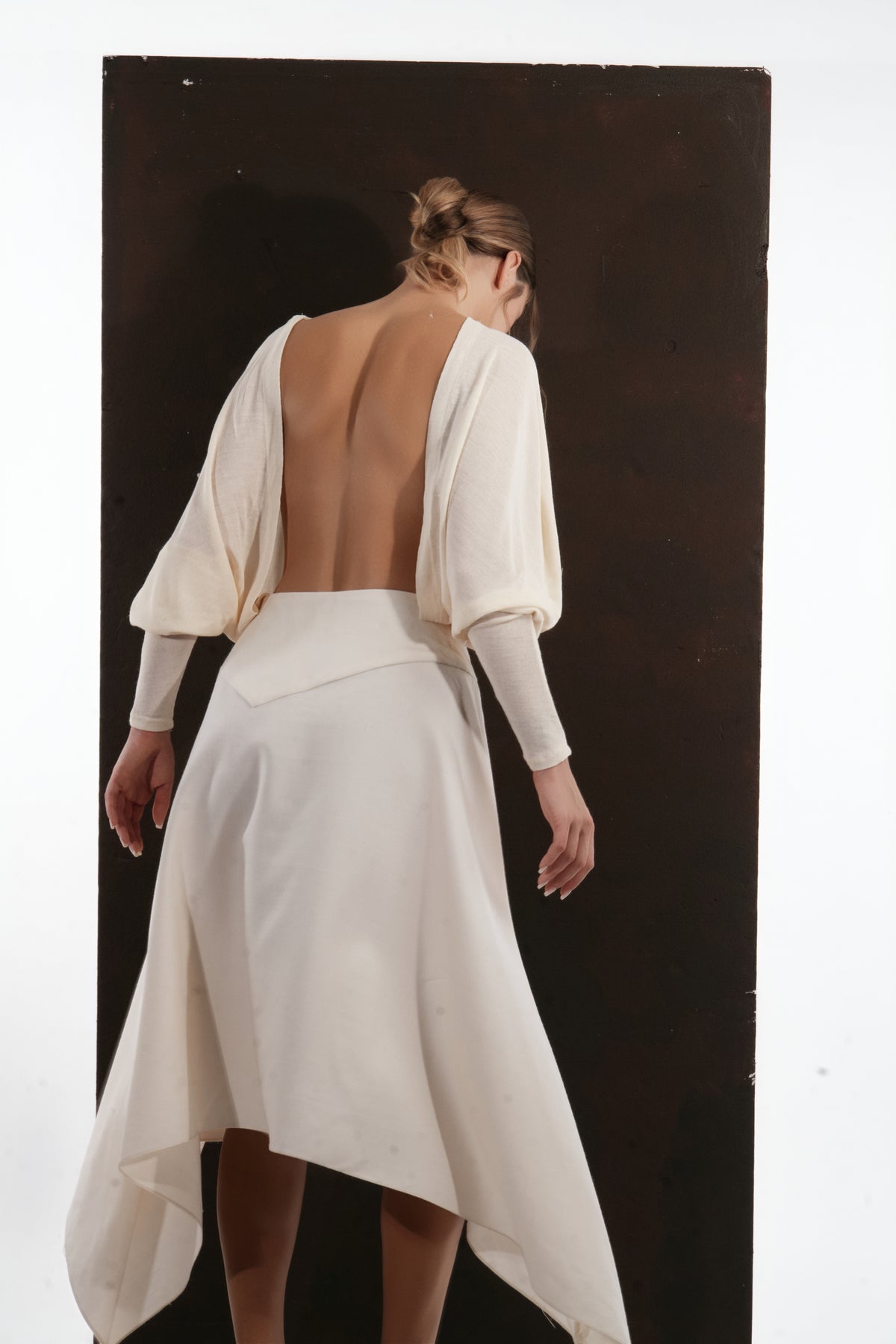 ALISADUDAJ ivory wool open-back drape dress, back view showing scooped open back and draped sleeves