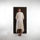 ALISADUDAJ ivory wool open-back drape dress, front view showing batwing sleeves and pointed skirt panels