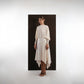 ALISADUDAJ ivory wool open-back drape dress, front three-quarter view showing pointed waist yoke