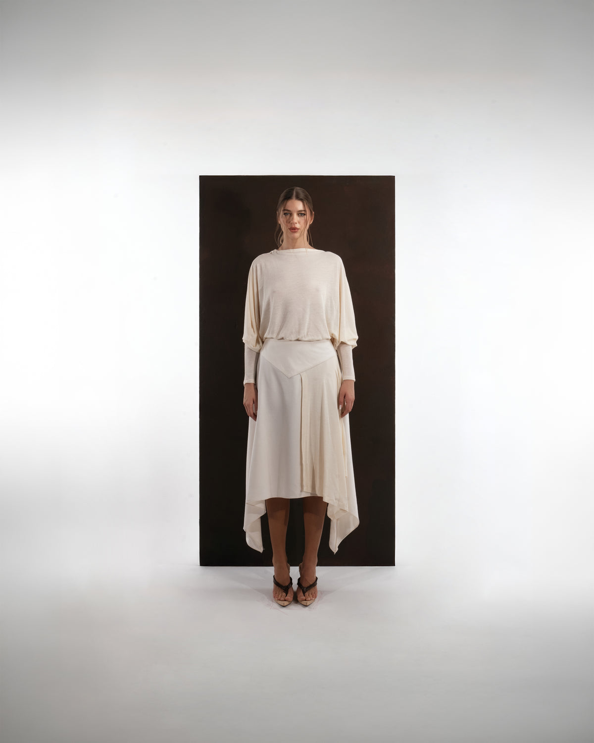 ALISADUDAJ ivory wool open-back drape dress, front view, full length, showing blouson bodice and handkerchief hem