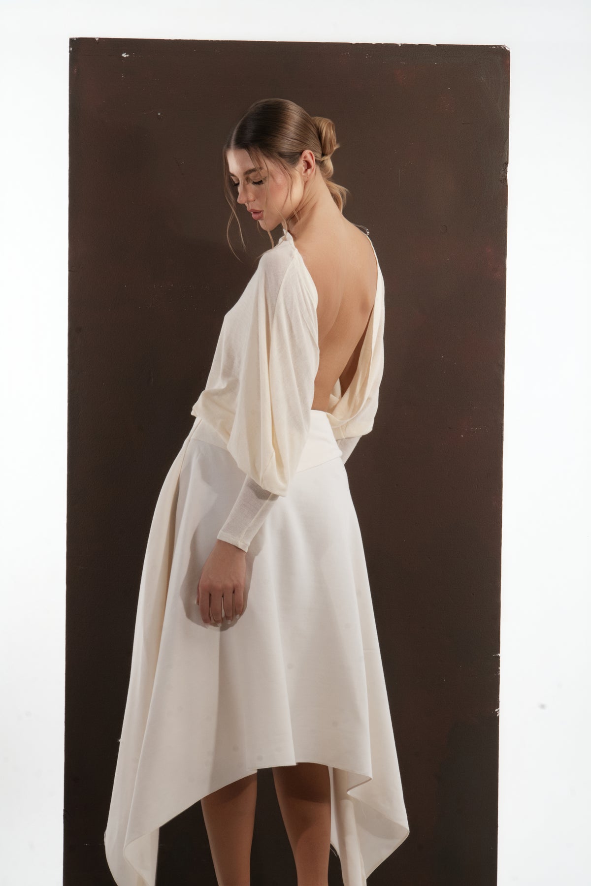 ALISADUDAJ ivory wool open-back drape dress, side back view showing open back and full sleeve