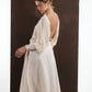 ALISADUDAJ ivory wool open-back drape dress, side view showing draped sleeve and handkerchief skirt