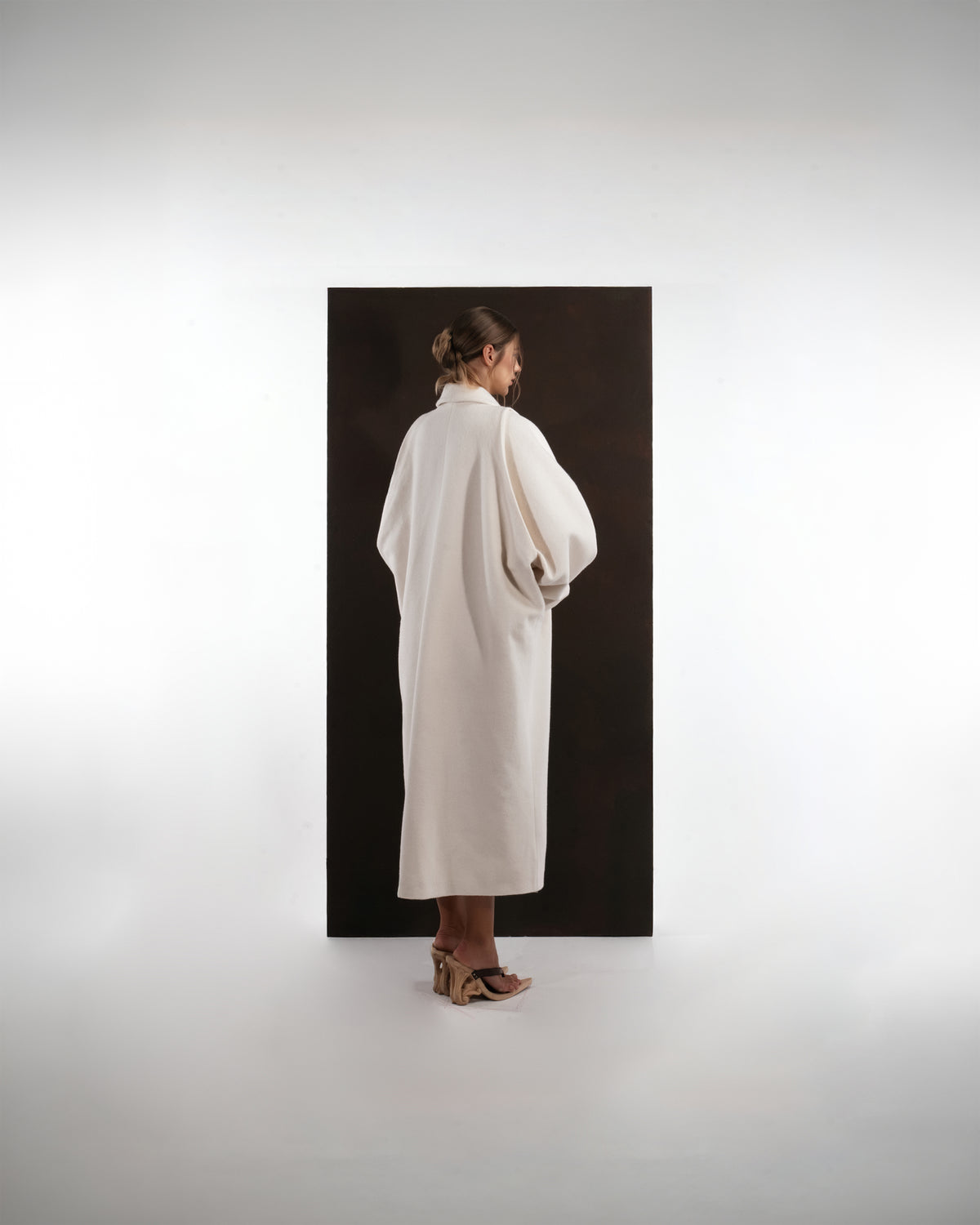 ALISADUDAJ ivory wool cocoon coat, back view showing full cocoon silhouette and dropped shoulders