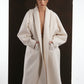 ALISADUDAJ ivory wool cocoon coat, front close-up of shawl collar, sleeve volume and pockets, wool blend