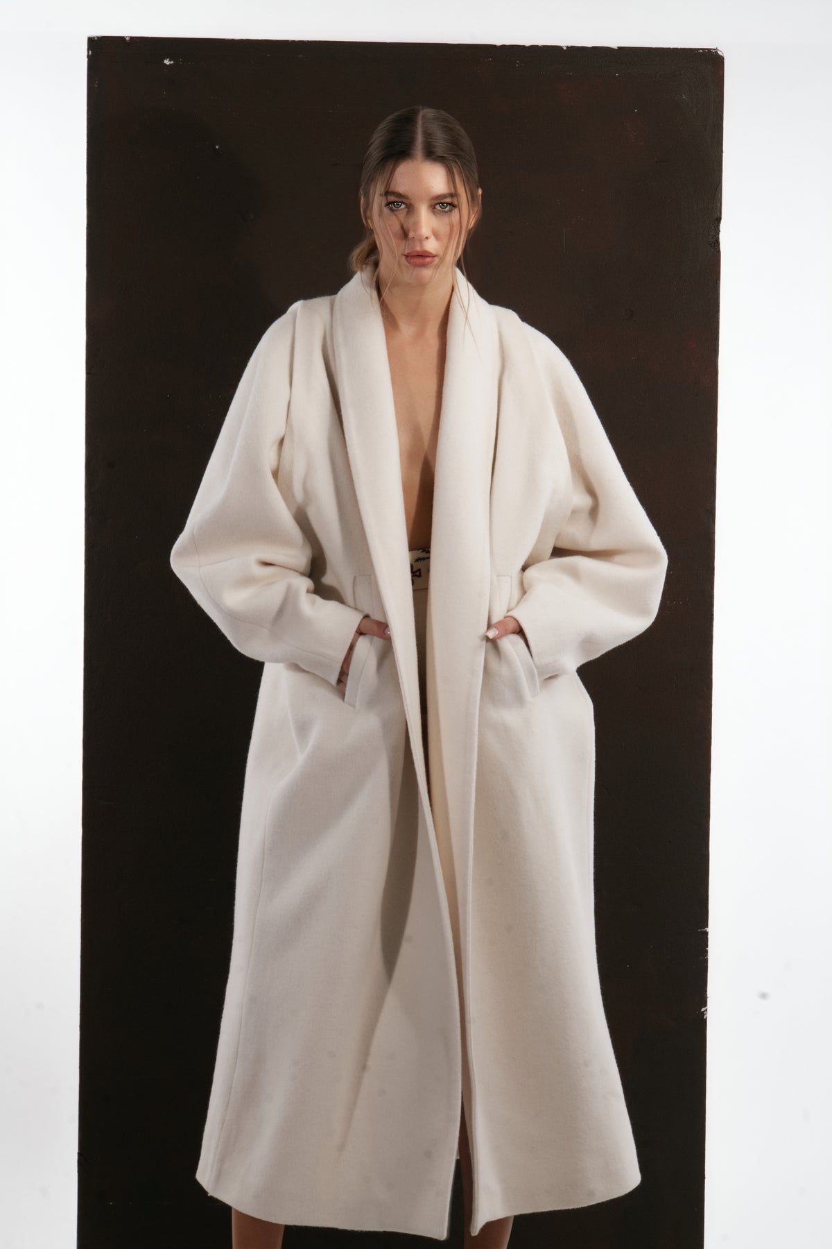 ALISADUDAJ ivory wool cocoon coat, front close-up of shawl collar, sleeve volume and pockets, wool blend