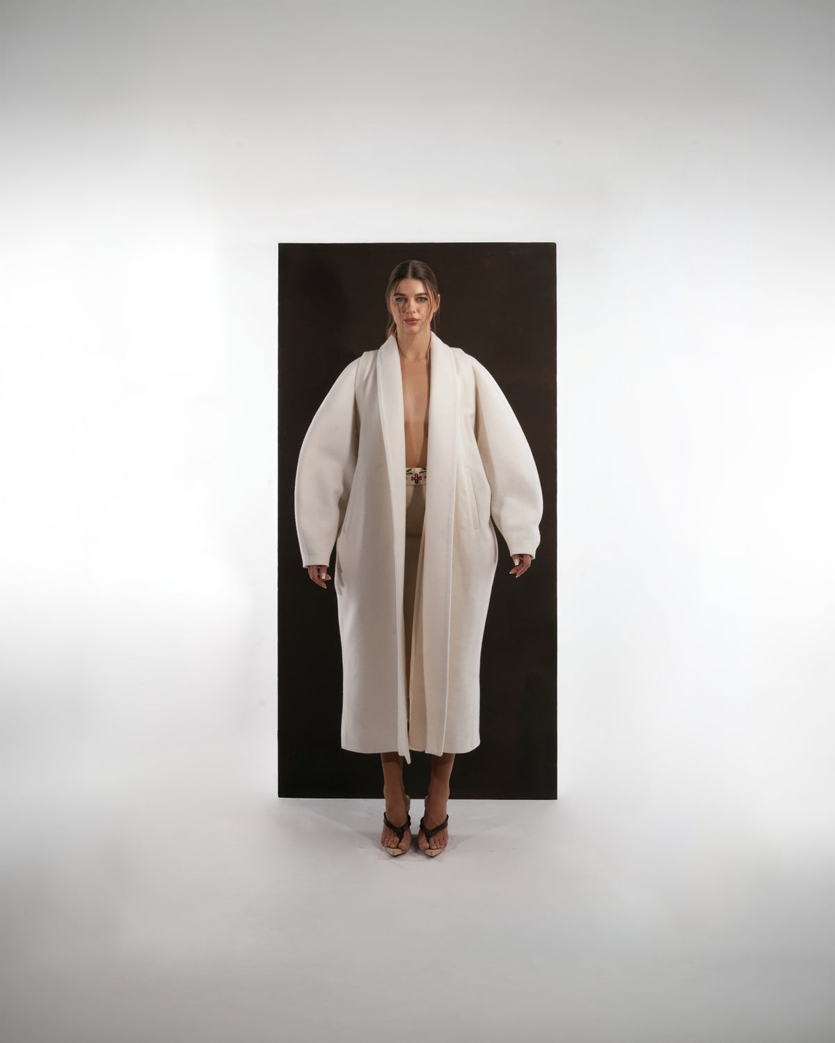 ALISADUDAJ ivory wool cocoon coat, front view showing rounded sleeve volume and wide shawl lapels