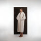 ALISADUDAJ ivory wool cocoon coat, three-quarter view with hands in pockets showing coat drape