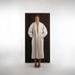 ALISADUDAJ ivory wool cocoon coat, front view with hands in pockets showing draped shawl collar