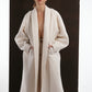 ALISADUDAJ ivory wool cocoon coat, half-length front view showing wide shawl collar and welt pockets