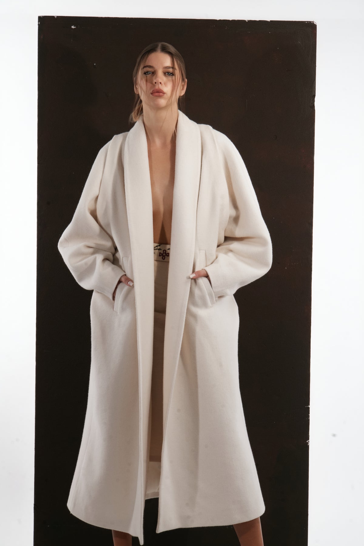 ALISADUDAJ ivory wool cocoon coat, half-length front view showing wide shawl collar and welt pockets