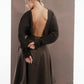 ALISADUDAJ mocha brown wool open-back dress, back view with hands behind the waist showing open back