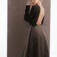 ALISADUDAJ mocha brown wool open-back dress, back three-quarter view with hand at the shoulder